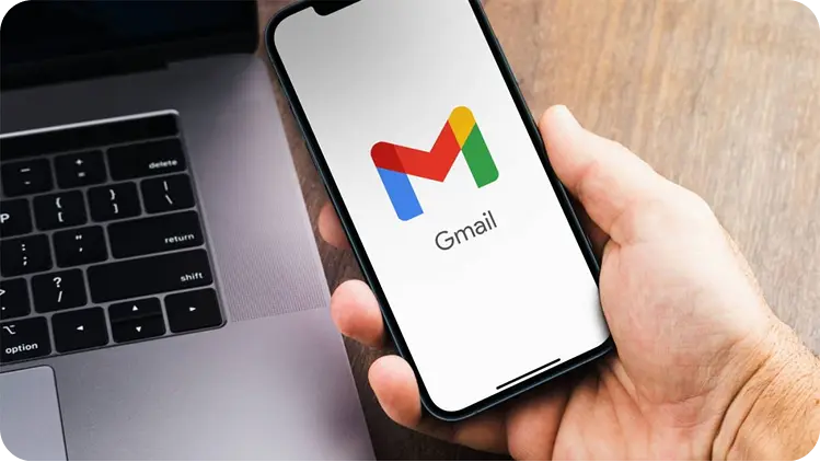 Hand holding phone with Gmail open